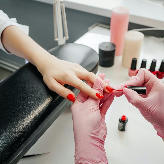 Young woman getting manicure in beauty salon